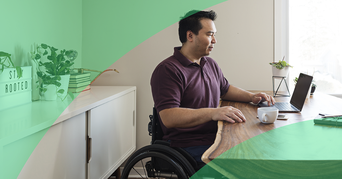 a man sitting at a desk with a laptop