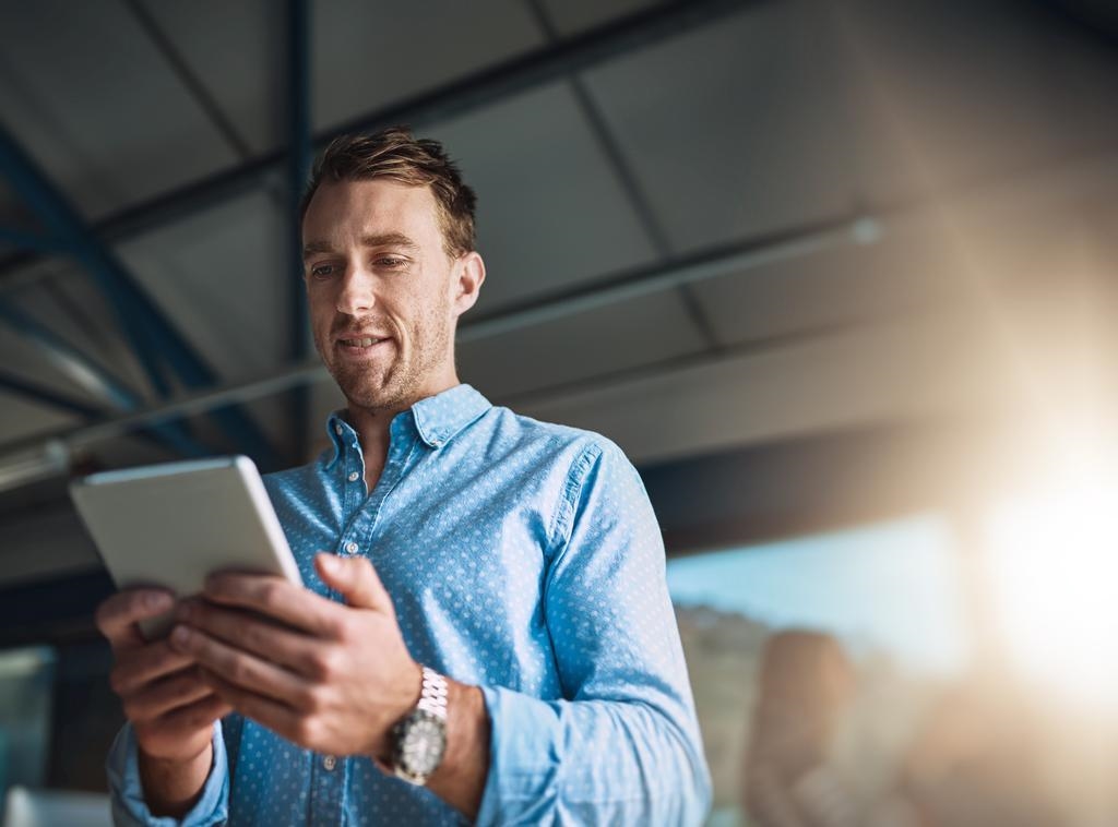 a man holding a tablet