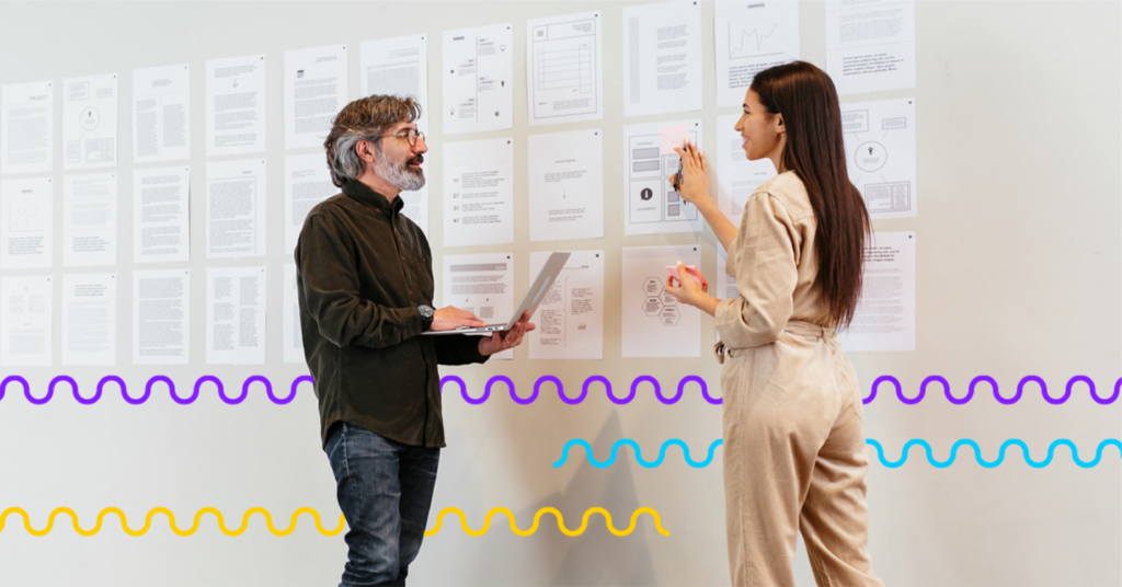 a man and a woman looking at a chart